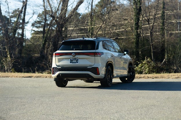 Rear three-quarter view of a white Volkswagen SUV parked outdoors.