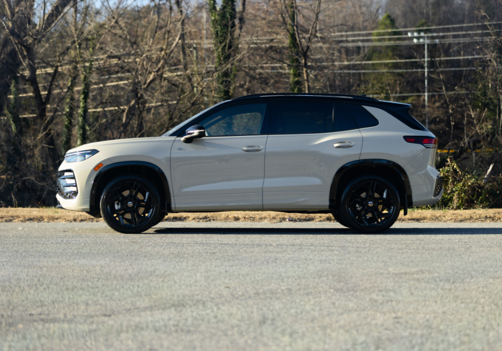 Driver's side exterior view of a 2026 Volkswagen Tiguan for sale. The car is parked and there are trees in the background.